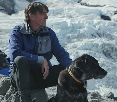 headshot of Peter Clark and his dog