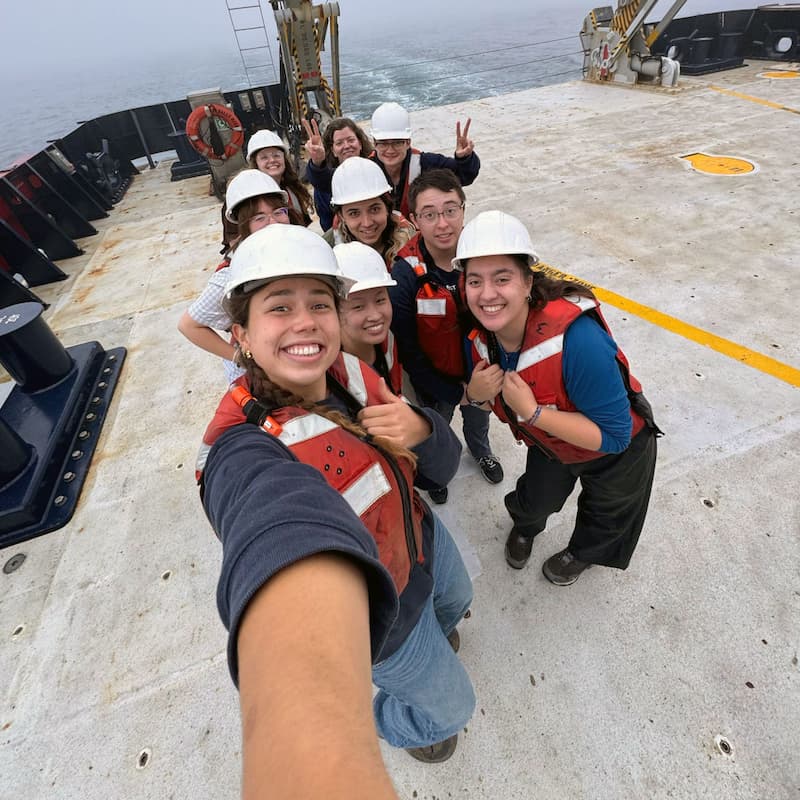 student group selfie aboard a ship at sea