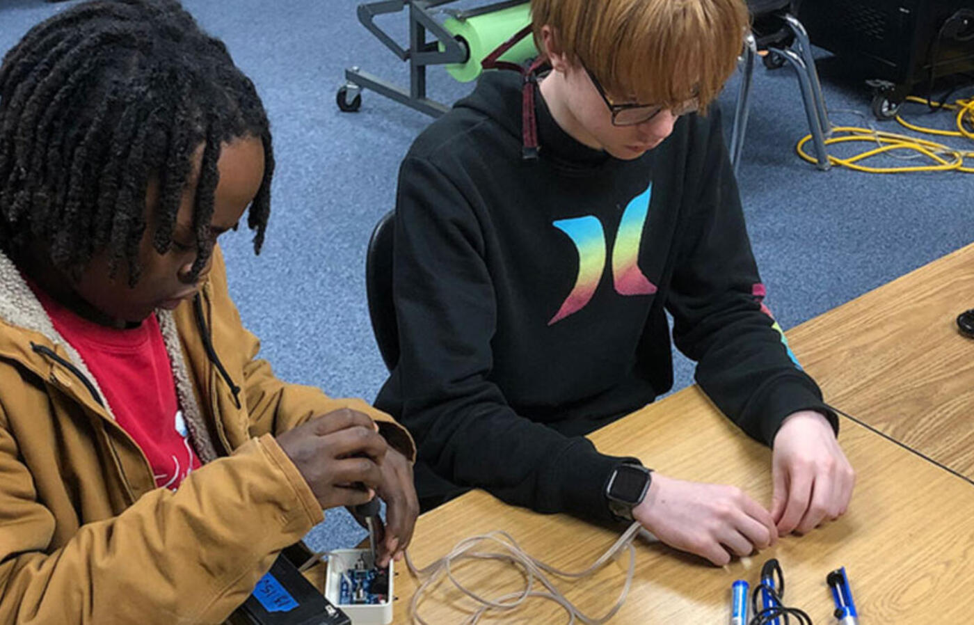 students working on electronic components