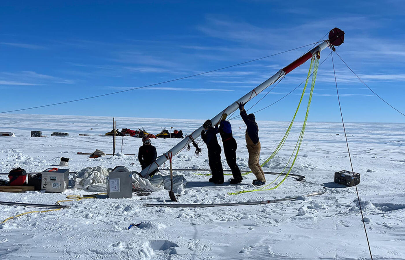 Four researchers setting up an ice drill