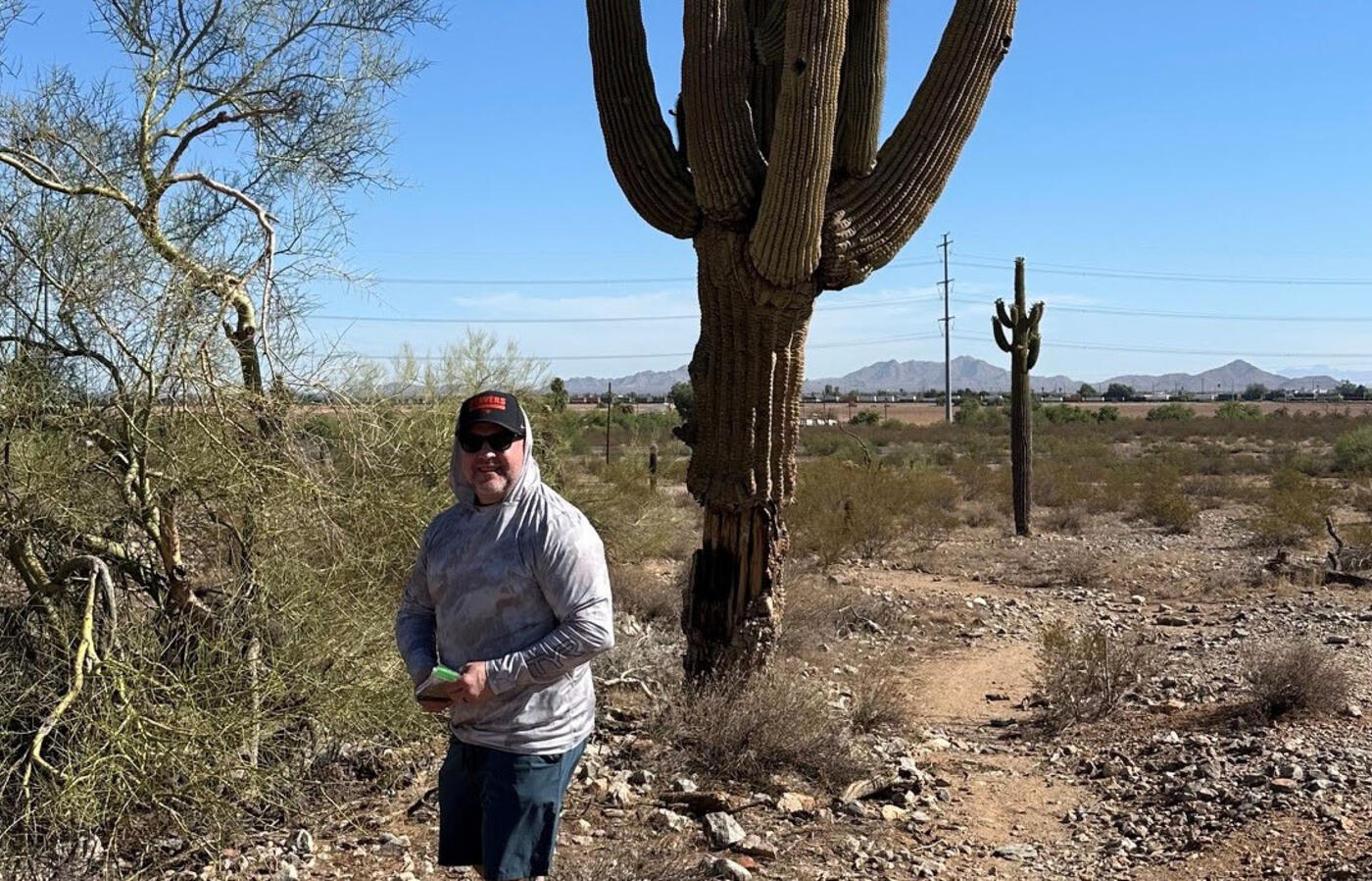 Shane takes measurements in the desert as part of an Ecampus environmental science class.