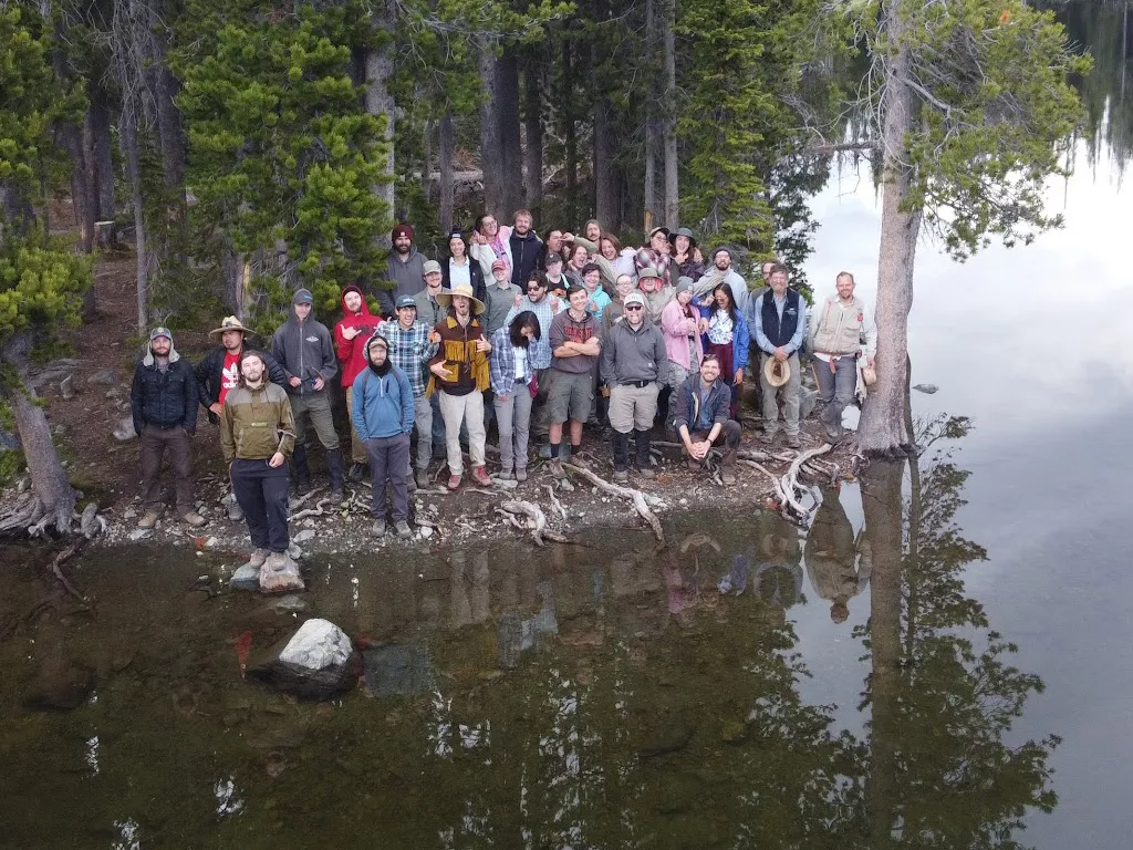 group of students on a lakeshore