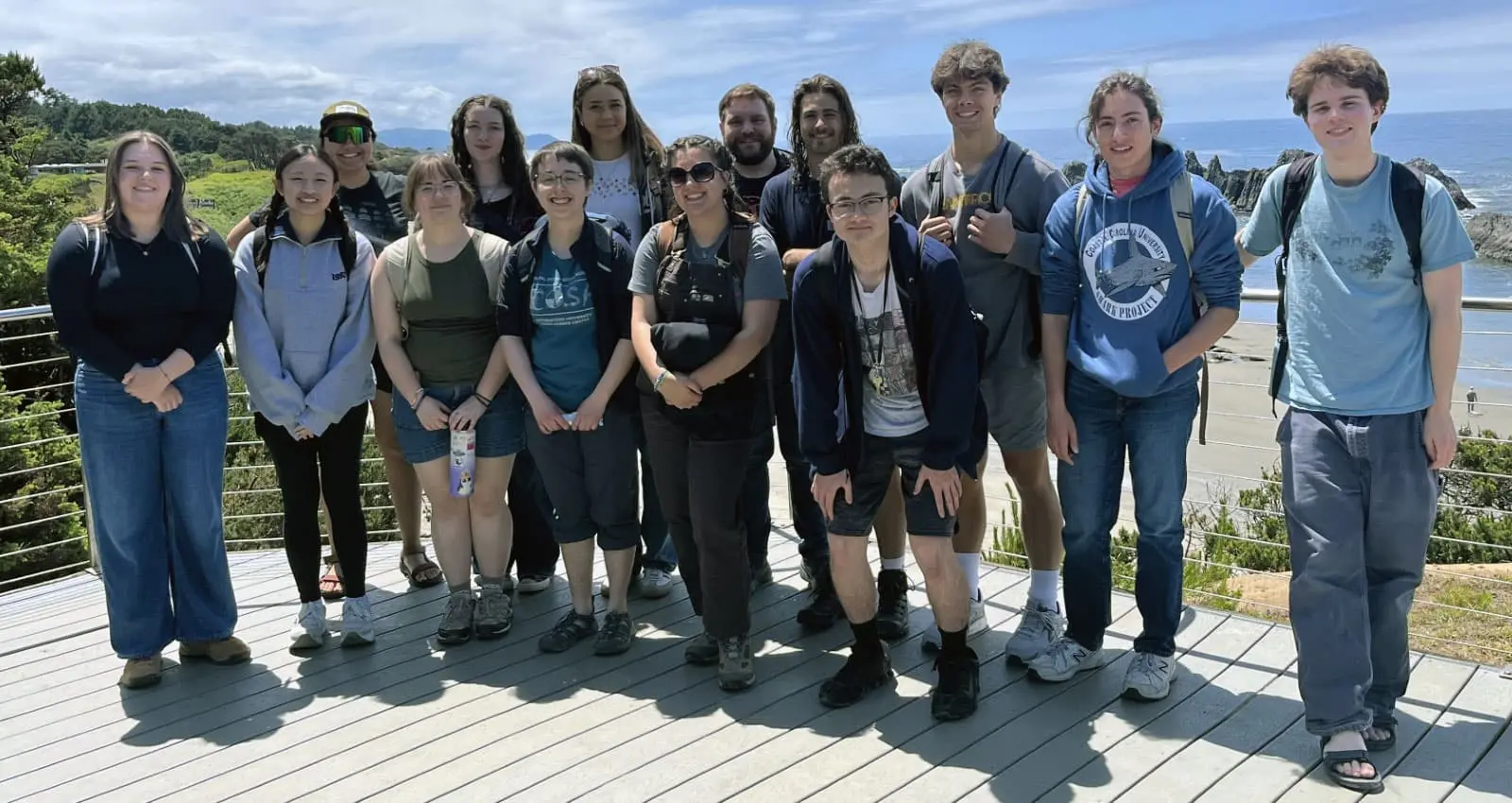 a group of students at the coast on a sunny day