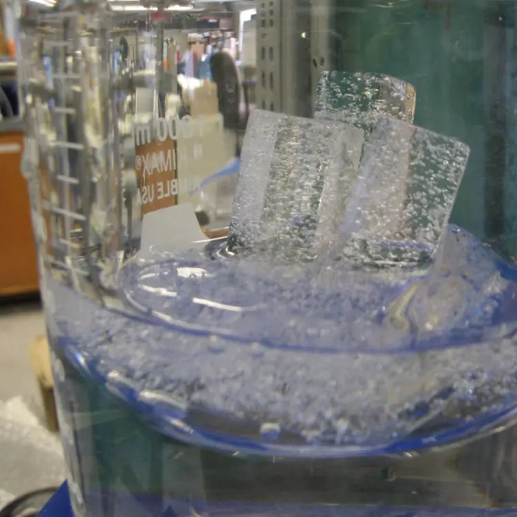 ice melting in a large glass container in a lab
