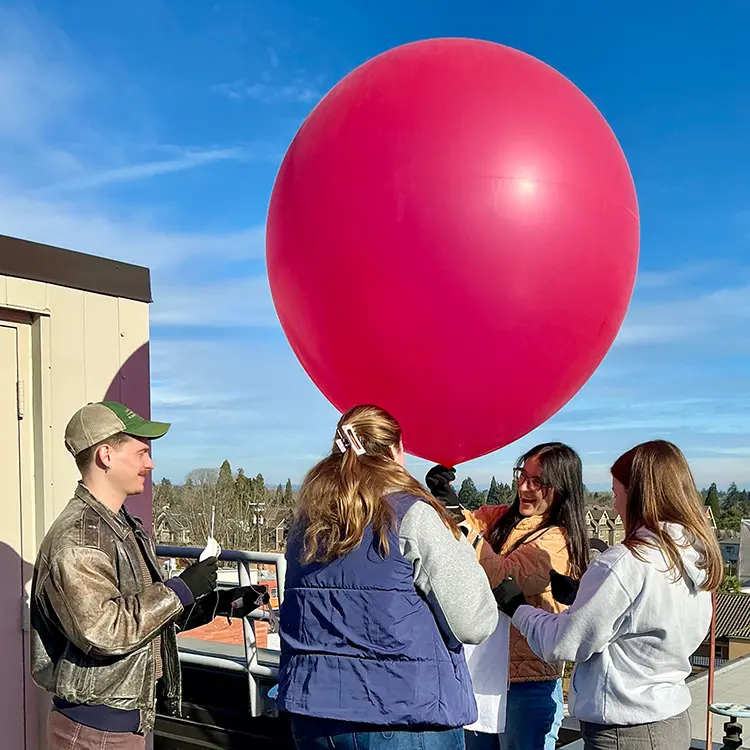 four students launching a weather balloon