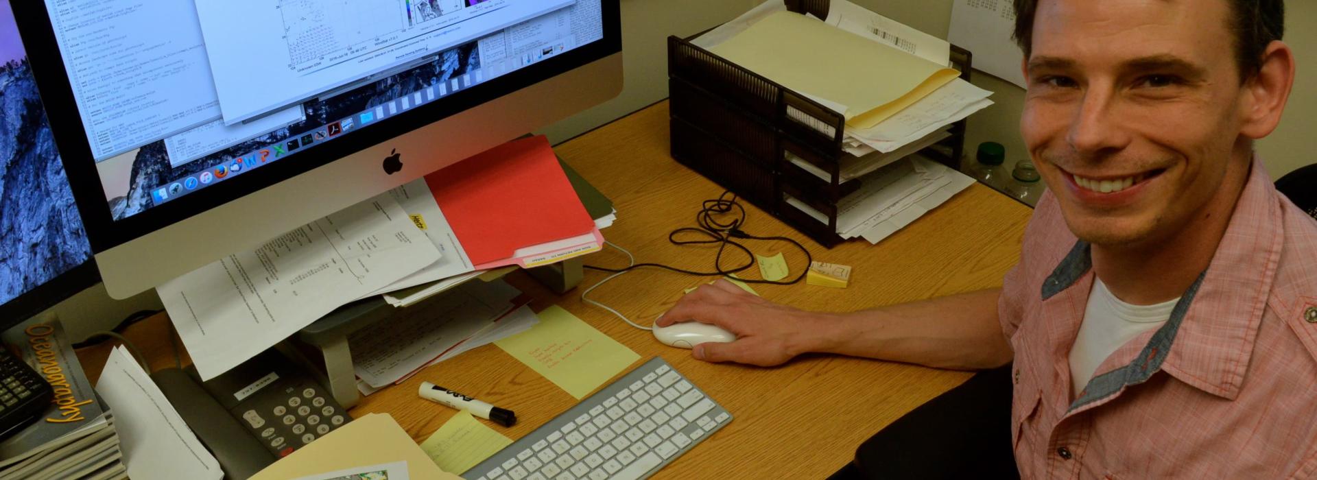 Larry O'Neill at his desk with a computer