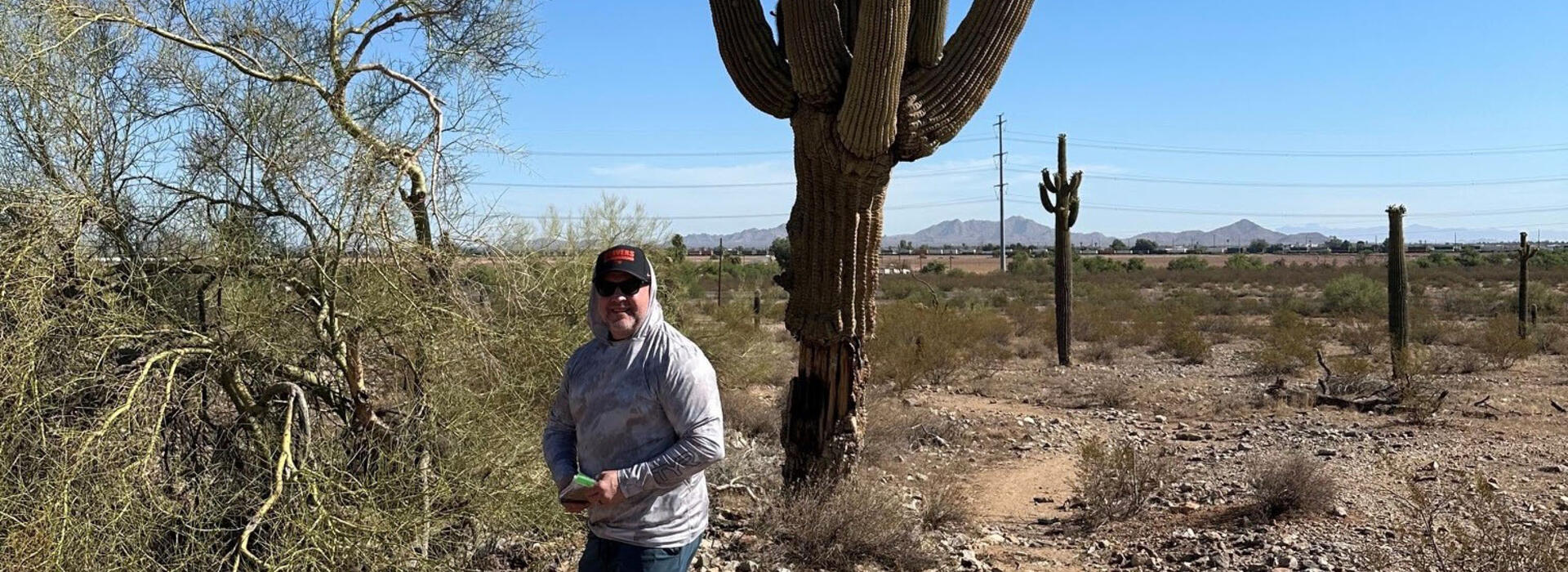 Shane takes measurements in the desert as part of an Ecampus environmental science class.