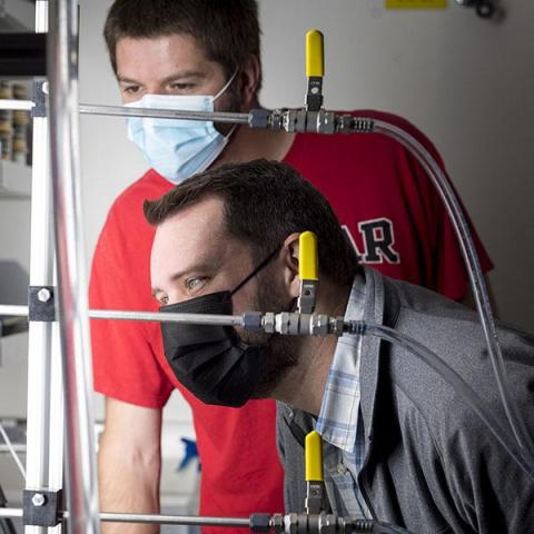 researchers looking at an instrument