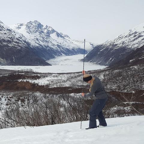 researcher measuring snow depth