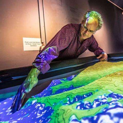 person manipulation a sand table