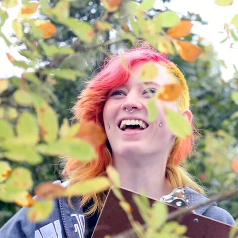 smiling student with a clipboard