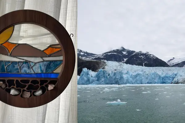 Meghan Sharp holds up her stained glass artwork next to a photo of the same glacier.